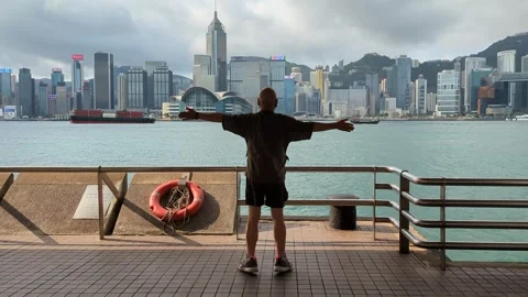 Man doing exercise at Hong Kong skyline waterfront Stock Footage 271238005