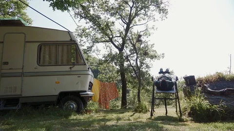 Man doing exercise on inversion table in nature to reduce back pain, relax, rest Stock Footage 127543167