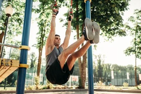 Man doing exercise on press using horizontal bar Stock-Fotos