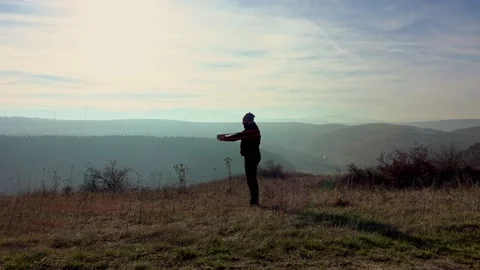 Man Doing Exercise With Rubber Band On Meadow Near City Stock Footage 165098931