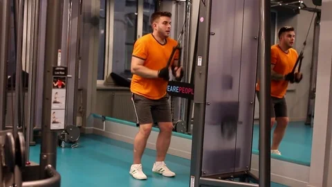 A man doing the exercise for the triceps at the gym Stock Footage 83129068