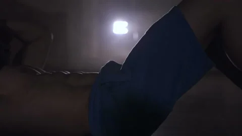 Man doing exercises for the abs. Dolly shot. Smoke at the backlight. Close up. Stock-Footage 89099789