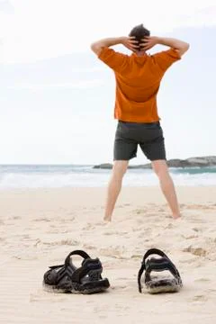 Man doing exercises on beach Stock Photos