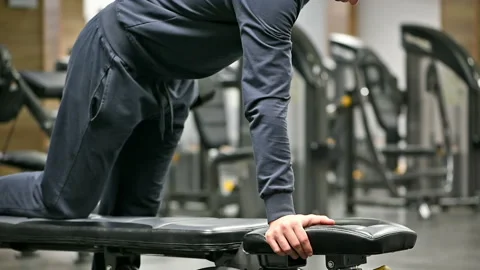 Man doing exercises with dumbbell in gym Stock Footage 85528893