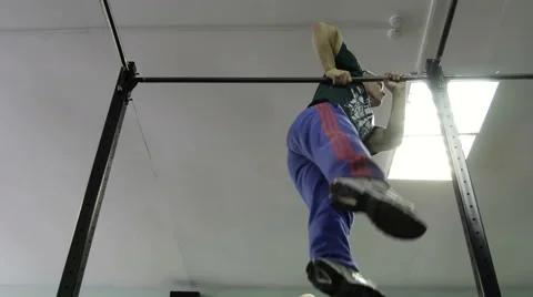 Man doing exercises on the horizontal bar in the gym Stock Footage 62365852