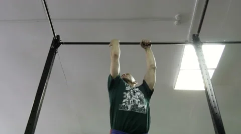 Man doing exercises on the horizontal bar in the gym Stock Footage 62365895