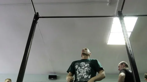 Man doing exercises on the horizontal bar in the gym Stock Footage 62365974