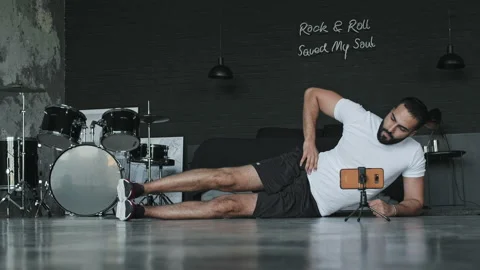 Man Doing Exercises In Music Studio And Shoots It On The Phone. Stock-Footage 140225431