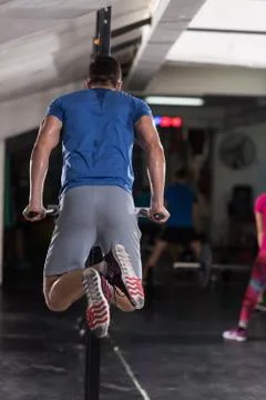Man doing exercises parallel bars Stock Photos