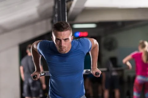 Man doing exercises parallel bars Stock Photos