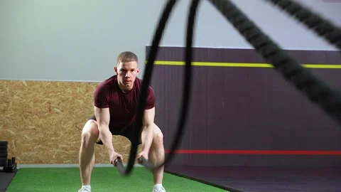 Man doing exercises with ropes during crossfit training at gym Stock Footage 102132730
