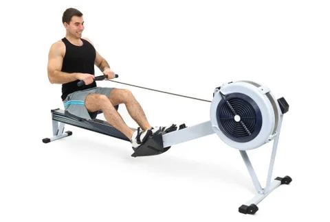 Man doing exercises on rowing machine, on white background Stock Photos