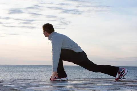 Man doing exercises at the sea Stock Photos