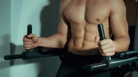 Man doing exercises on the simulator Stock Photos