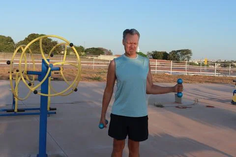 Man doing External Shoulder Rotation exercise with light weights for should pain Foto stock