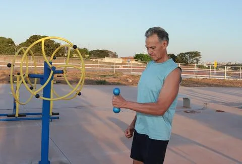 Man doing External Shoulder Rotation exercise with light weights for should pain Stock Photos
