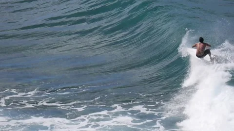Man doing a few turns on a wave throwing nice sprays Stock Footage 131335932