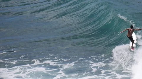 Man doing a few turns on a wave throwing nice sprays, slow motion. Stock Footage 131335998