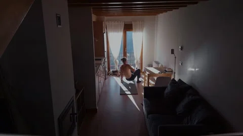 Man doing functional training at home with dog indoor fitness scene Stock Footage 332557760