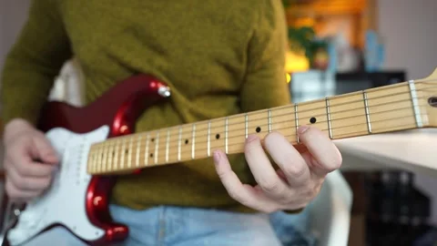 Man doing guitar exercises for left hand on red double cut electric guitar. Stock Footage 340905602