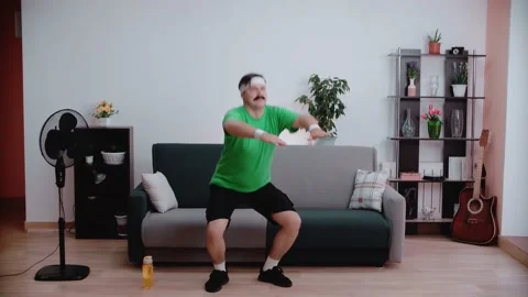 A man doing gymnastic exercises squatting. Fitness classes at home. Stock Footage 146265112