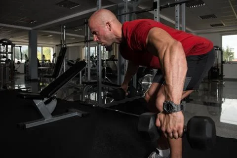 Man Doing Heavy Weight Exercise For Back Stock Photos