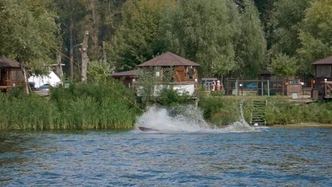 Man doing high backflip on wakeboard barely landing it Stockbeeldmateriaal 116055467