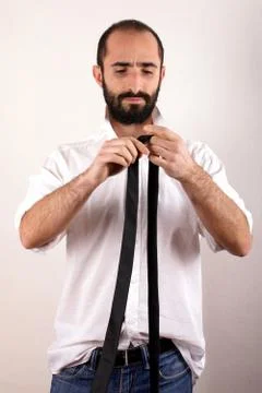 Man doing his tie Stock Photos