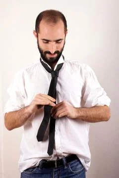 Man doing his tie Stock Photos