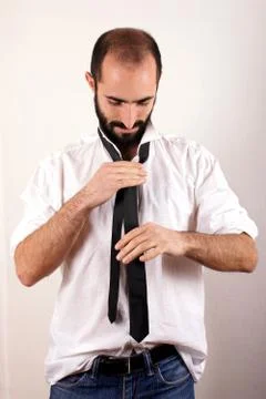 Man doing his tie Stock Photos