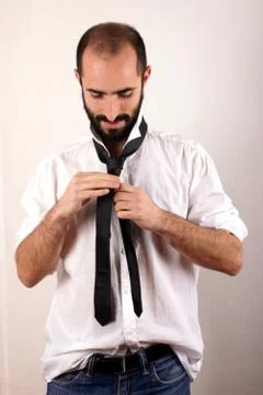 Man doing his tie Stock Photos