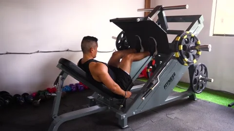 A man doing an incline leg press exercise Stock Footage 146501397