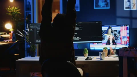 Man doing IT support job from home office, stretching after sitting at desk Stock Footage 265618305