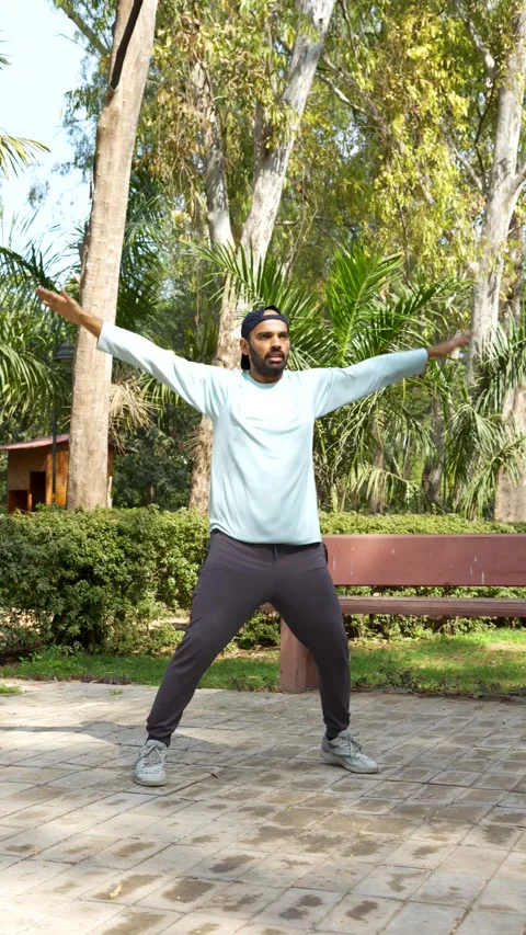 Man Doing Jumping Jacks in Park Stock Footage 340213291