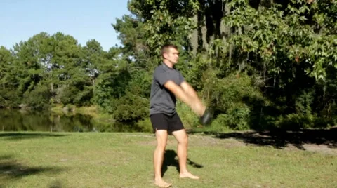Man doing a kettlebell workout outside Stock Footage 8778184