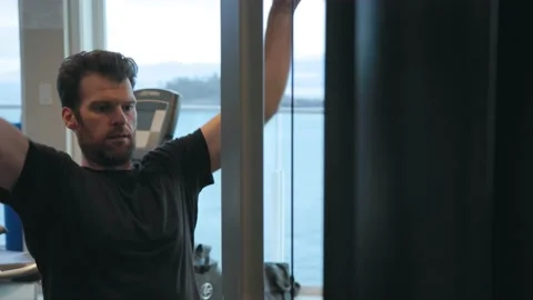Man doing lateral pull downs at the gym, working out, pull down, motivation, in Stock Footage 230199592