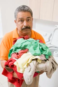 Man doing laundry Stock Photos