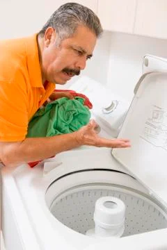 Man doing laundry Stock Photos