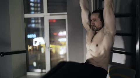 Man doing leg lifting on a horizontal bar 스톡 동영상 74279444