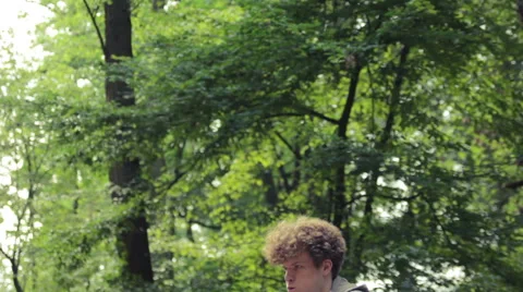 Man doing leg raises on a keep-fit trail Stock Footage 41098595