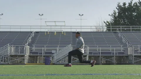 Man Doing Lunges On Field Stock Footage 210219512