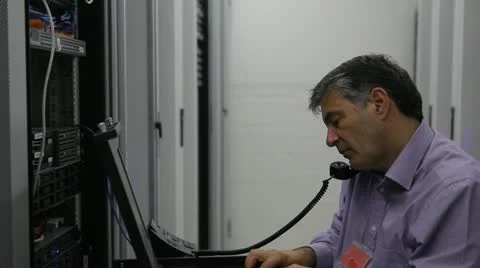 Man doing maintenance while calling Stock Footage