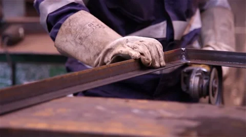 Man doing metalworking using a grinding wheel Stock Footage 56626116