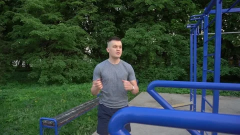 Man is doing morning exercise. Man does gymnastic exercises. Fitness classes at Stock Footage 89450112