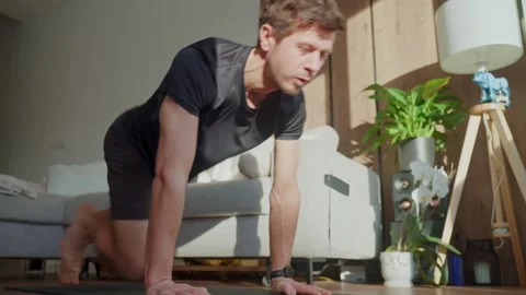 Man doing mountain climber exercise on fitness mat at home Stock Footage 327631590