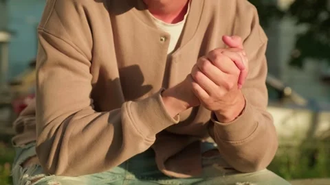 Man doing a nervous hand gesture. Close up of a man sitting outdoors with h.. Stock Footage 339547310