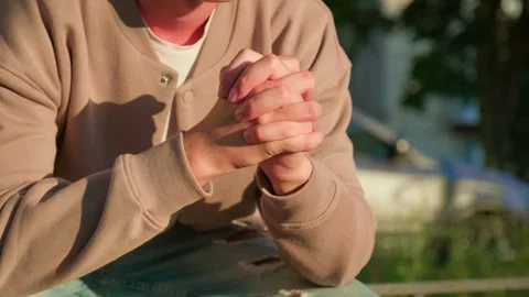 Man doing a nervous hand gesture. Close up of a man sitting outdoors with h.. Stock Footage 339547346
