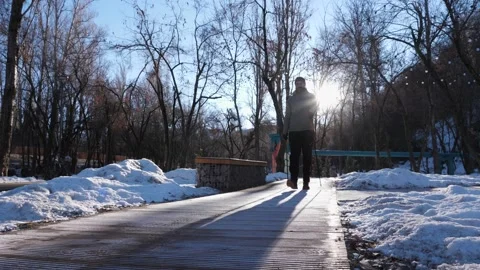 Man doing Nordic walking in winter park early in the morning Stock Footage 209825021