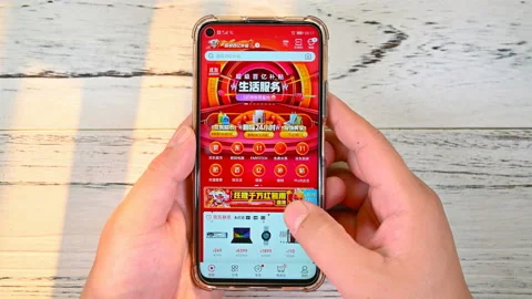 Man doing online shopping on a mobile app named JingDong. Stock Footage 127271972