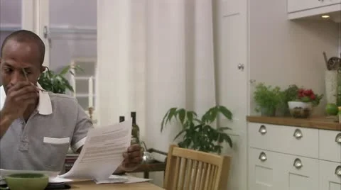 A man doing paper work at home Stock-Footage 11337596